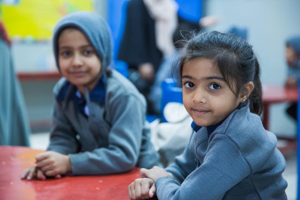 Two Qalam School students sharing a desk